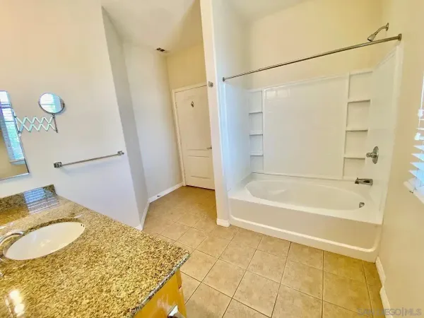 a bathroom with a mirror and a shower