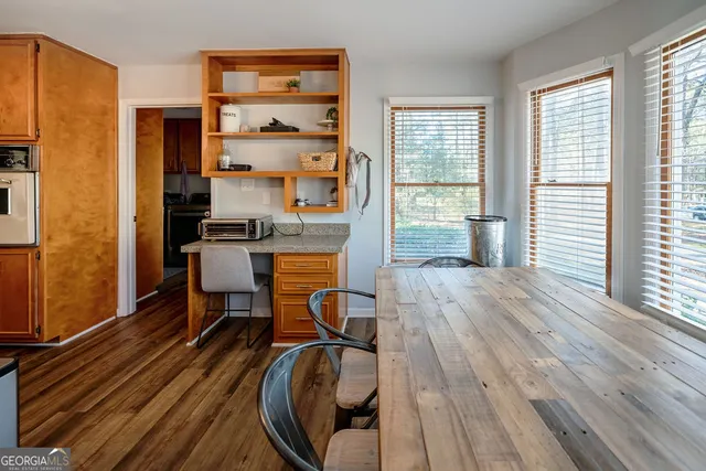 a view of a workspace with furniture and wooden floor