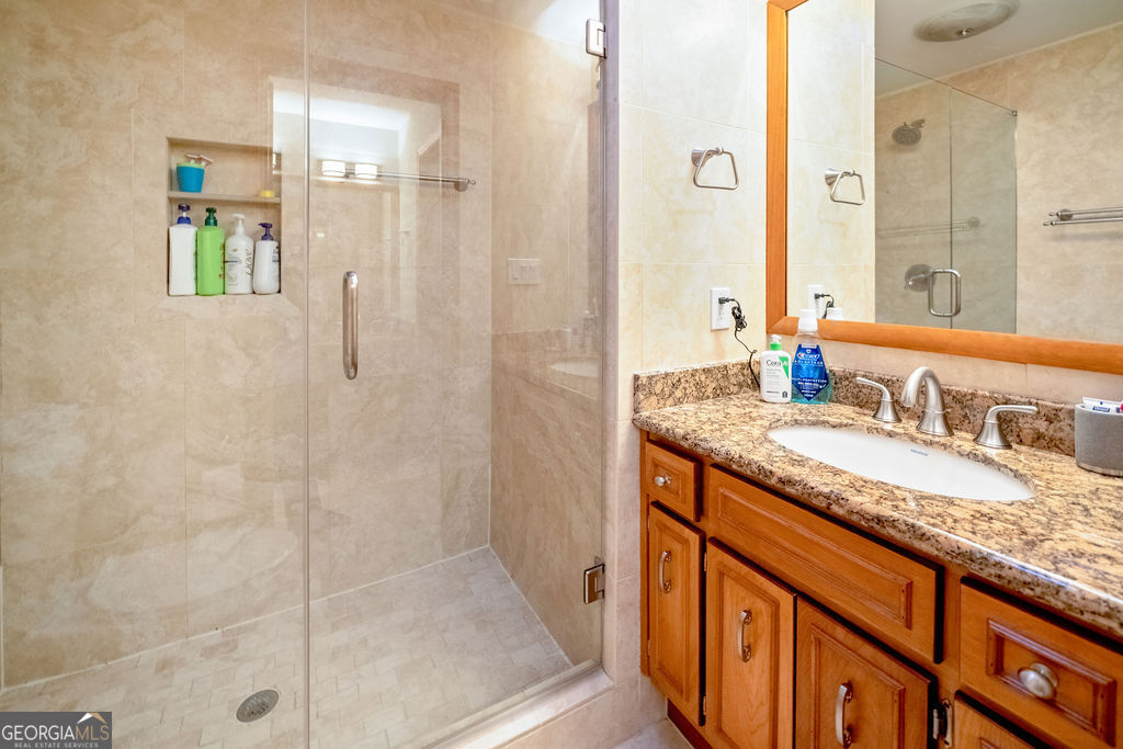 115 Devilla Trace Fayetteville, GA 30214 - Photo 18 of 30 a bathroom with a granite countertop sink and a mirror
