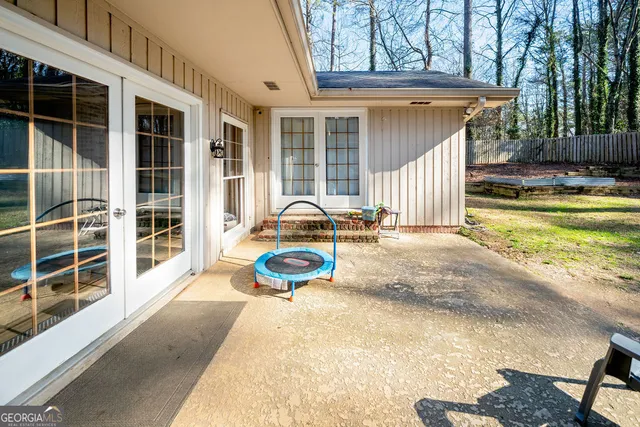 a view of a house with backyard and sitting area