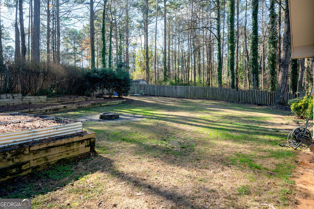 115 Devilla Trace Fayetteville, GA 30214 - Photo 25 of 30 a view of swimming pool with a yard and large trees