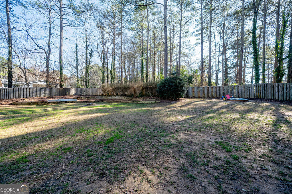 115 Devilla Trace Fayetteville, GA 30214 - Photo 26 of 30 a view of the house with large trees and a yard
