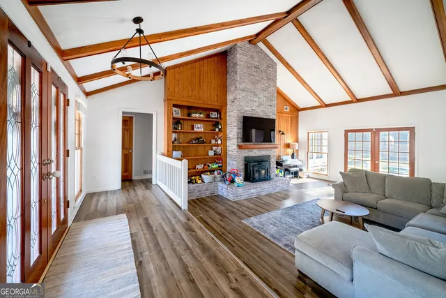 a living room with furniture a fireplace and a flat screen tv