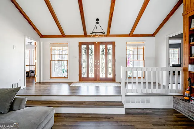 a living room with furniture and a floor to ceiling window
