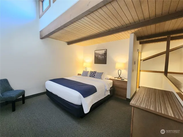 a spacious bathroom with a double vanity sink a toilet and a mirror