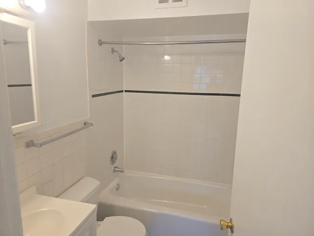 a bathroom with a shower and a bath tub