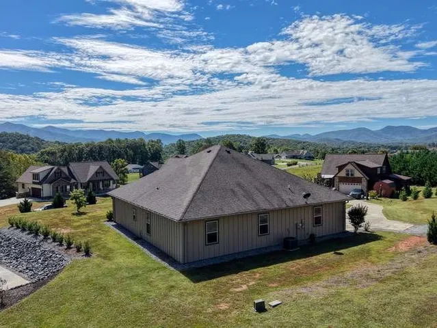 a living room with furniture fireplace and a large window