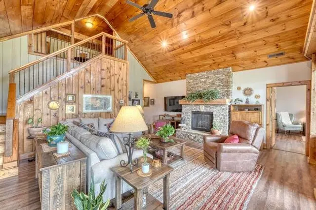 a living room with furniture and a floor to ceiling window