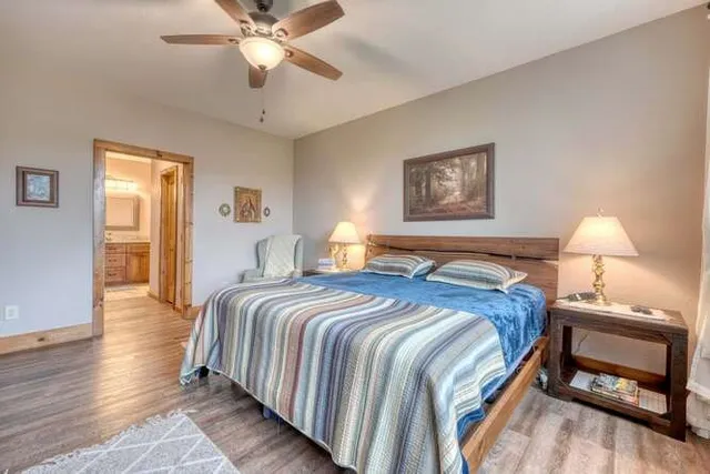 a bedroom with a large bed and a chandelier