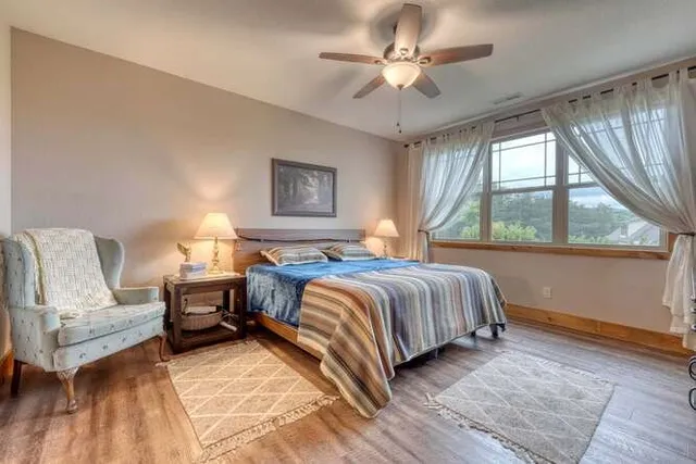 a bedroom with a large bed and a chandelier