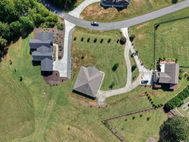 a front view of a house with swimming pool having outdoor seating