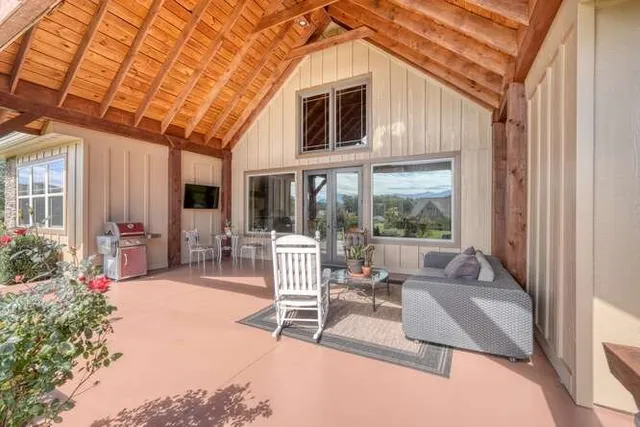 a building outdoor space with patio furniture and potted plants