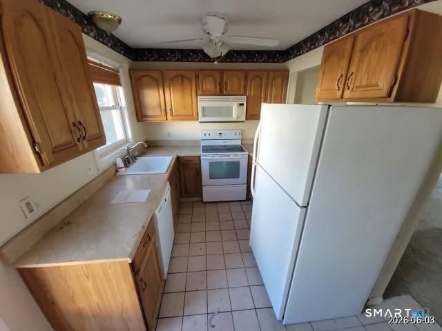 28 Commodore Cmns, Unit 28 Derby, CT 06418 - Photo 6 of 17 a kitchen with a refrigerator a sink and dishwasher a stove top oven with wooden floor