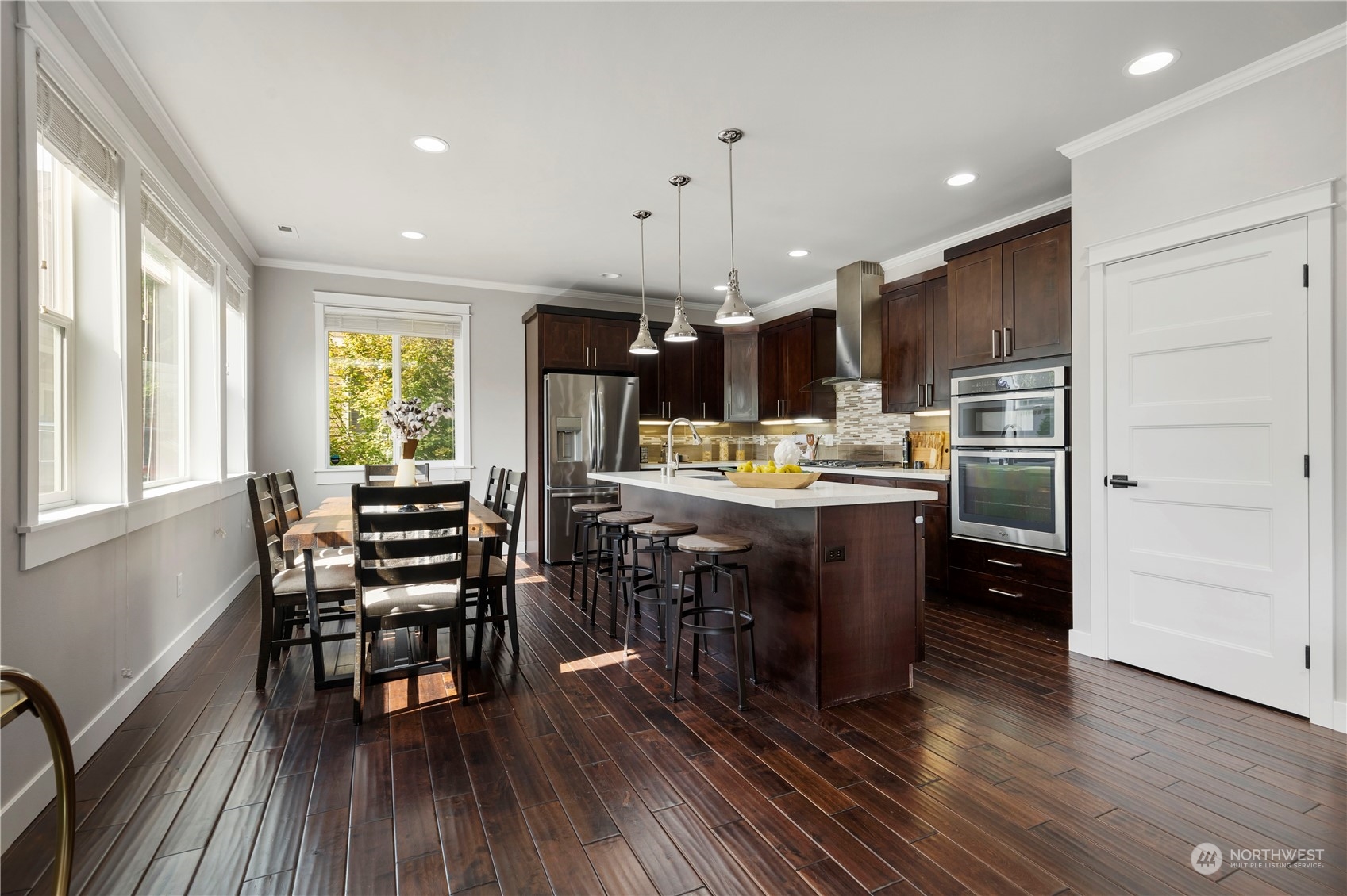 19730 Filbert Drive Bothell, WA 98012 - Photo 11 of 35 a kitchen with stainless steel appliances kitchen island granite countertop a table chairs and a refrigerator