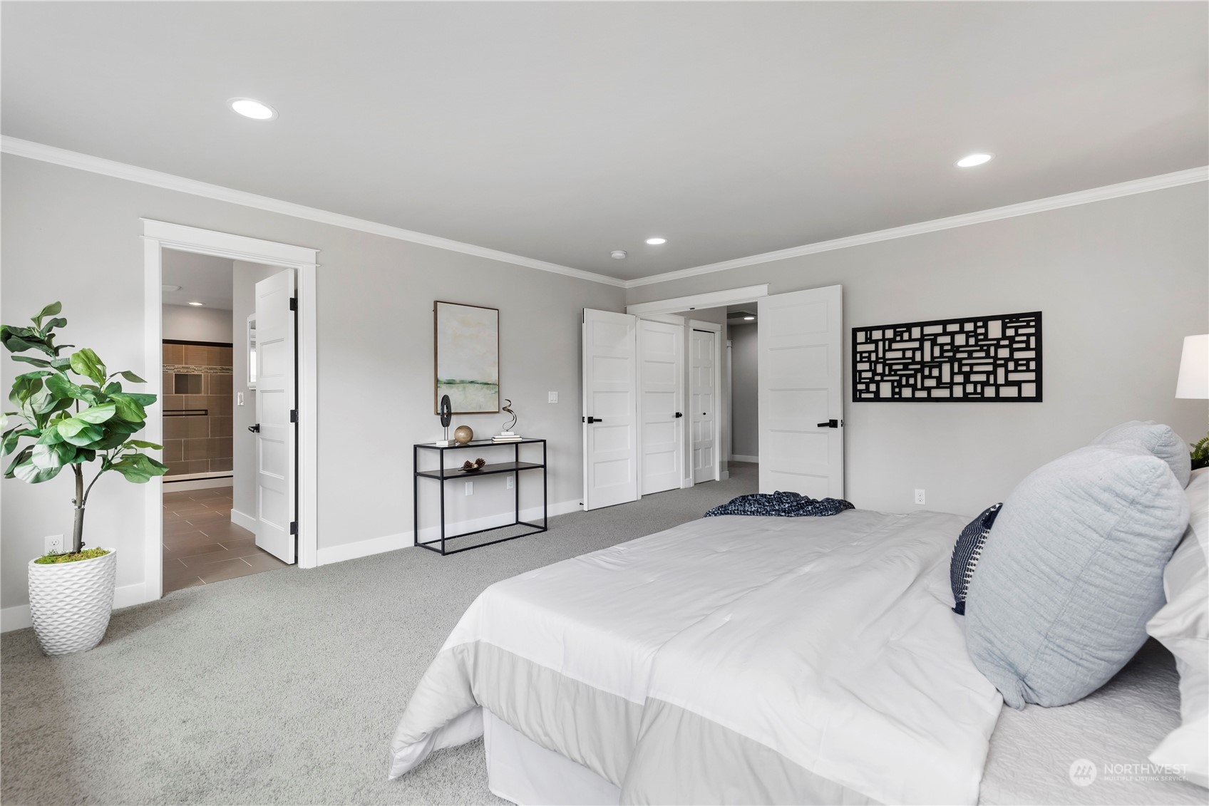 19730 Filbert Drive Bothell, WA 98012 - Photo 27 of 35 a spacious bedroom with a bed and a potted plant