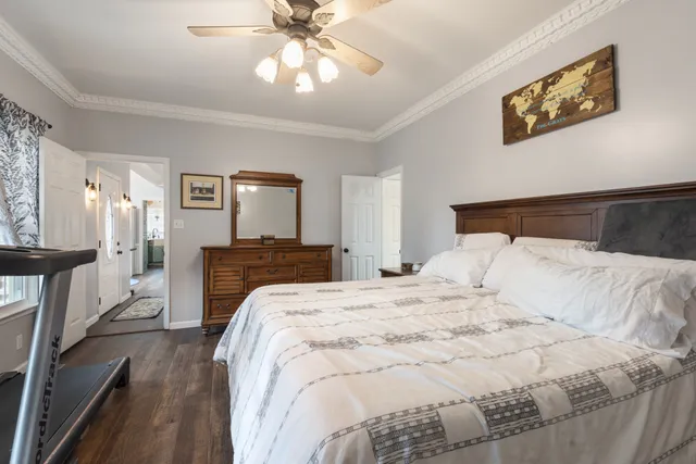 a bedroom with a large bed and a chandelier