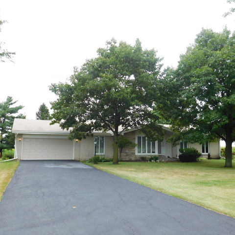 10471 Lee Road Waterman, IL 60556 - Photo 1 of 20 a front view of a house with a yard and garage