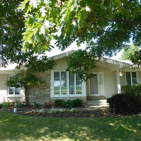 10471 Lee Road Waterman, IL 60556 - Photo 2 of 20 a front view of a house with a yard and trees