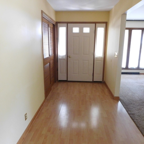 10471 Lee Road Waterman, IL 60556 - Photo 3 of 20 an empty room with wooden floor and windows