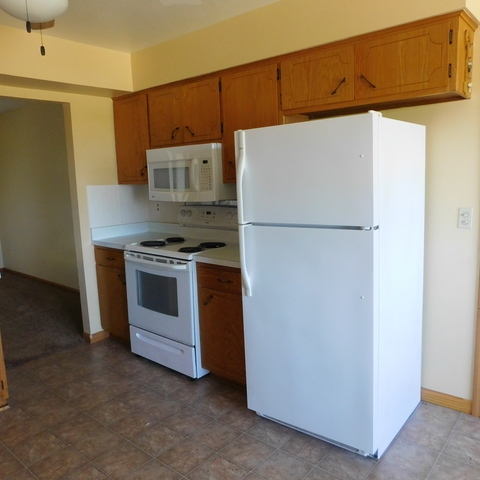 10471 Lee Road Waterman, IL 60556 - Photo 8 of 20 a white refrigerator freezer and a stove sitting inside of a kitchen