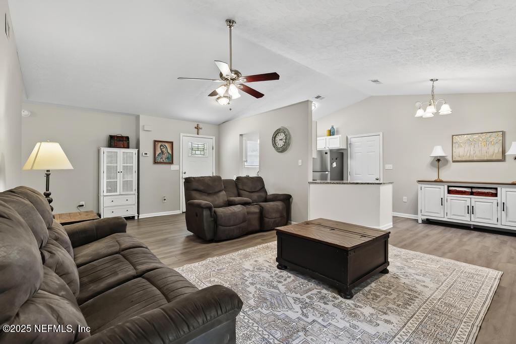 17080 Mcintosh Road Hilliard, FL 32046 - Photo 11 of 52 a living room with furniture and a chandelier