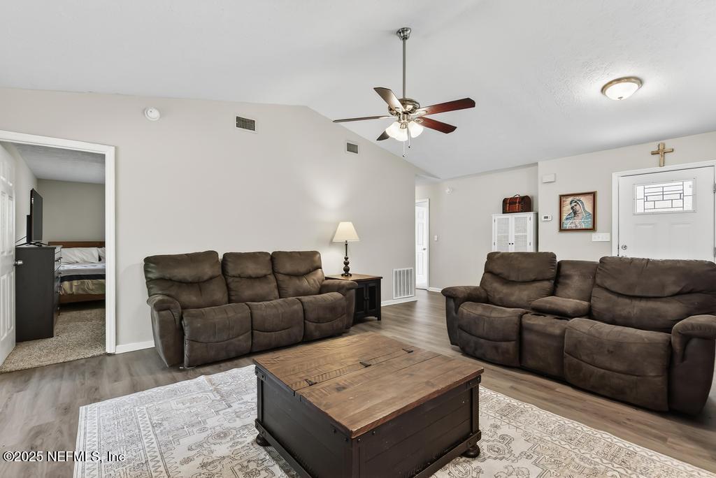 17080 Mcintosh Road Hilliard, FL 32046 - Photo 12 of 52 a living room with furniture and a ceiling fan