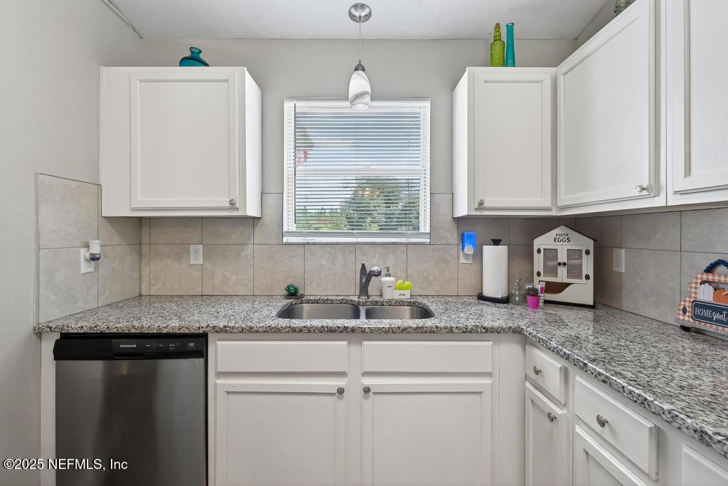 17080 Mcintosh Road Hilliard, FL 32046 - Photo 14 of 52 a kitchen with granite countertop white cabinets and a sink