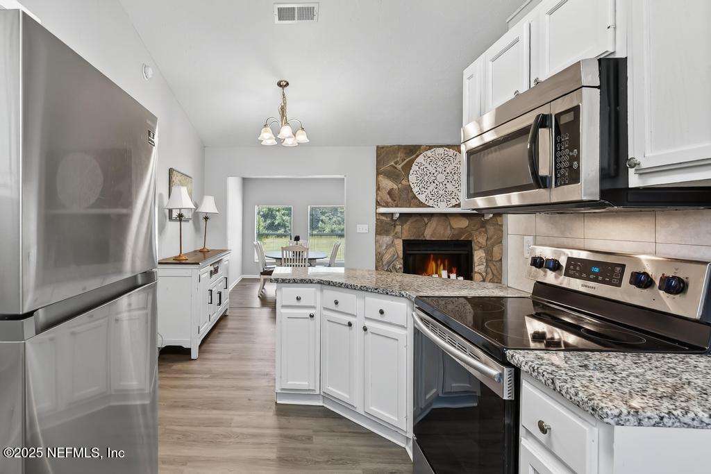 17080 Mcintosh Road Hilliard, FL 32046 - Photo 15 of 52 a kitchen with a stove and a microwave