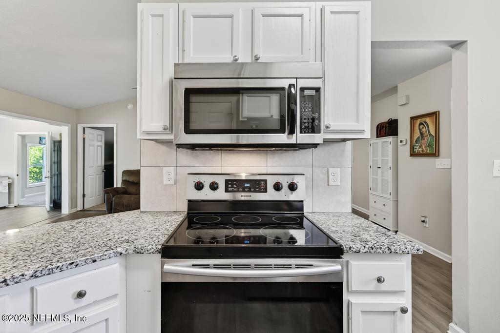 17080 Mcintosh Road Hilliard, FL 32046 - Photo 17 of 52 a stove top oven sitting inside of a kitchen