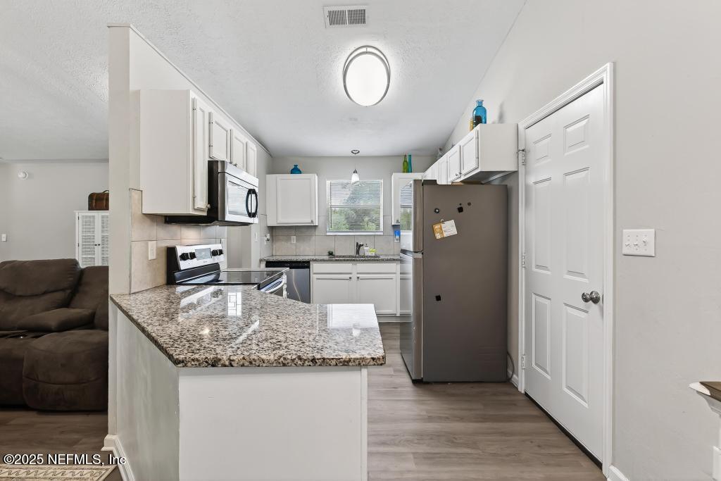 17080 Mcintosh Road Hilliard, FL 32046 - Photo 18 of 52 a kitchen with refrigerator and cabinets
