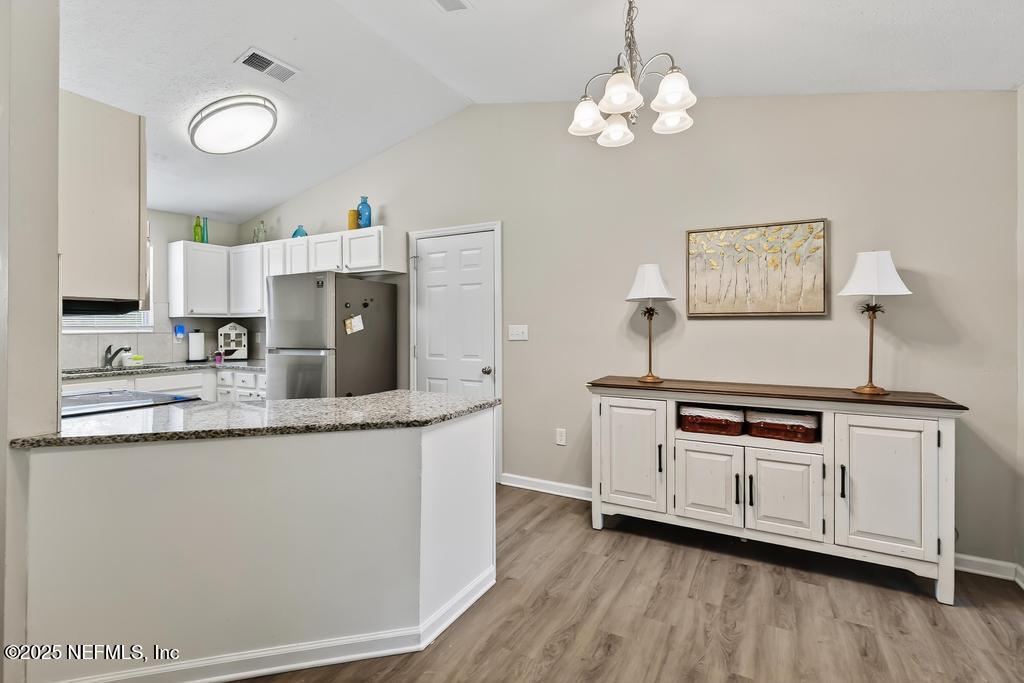 17080 Mcintosh Road Hilliard, FL 32046 - Photo 19 of 52 a kitchen with stainless steel appliances granite countertop a stove a sink and a refrigerator