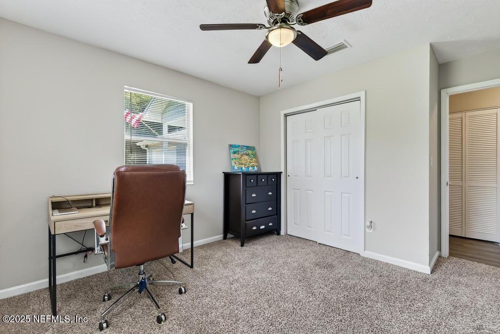 17080 Mcintosh Road Hilliard, FL 32046 - Photo 24 of 52 a workspace with a bookshelf