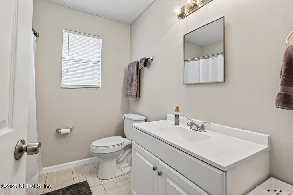 17080 Mcintosh Road Hilliard, FL 32046 - Photo 25 of 52 a bathroom with a sink toilet and mirror