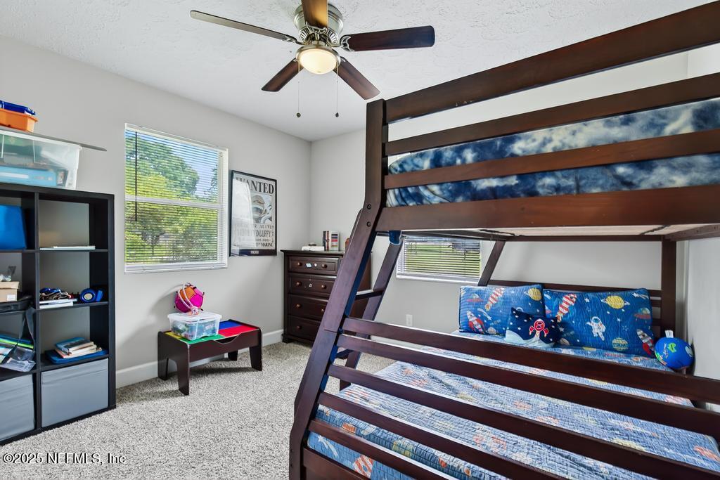 17080 Mcintosh Road Hilliard, FL 32046 - Photo 26 of 52 a living room with furniture and a fireplace