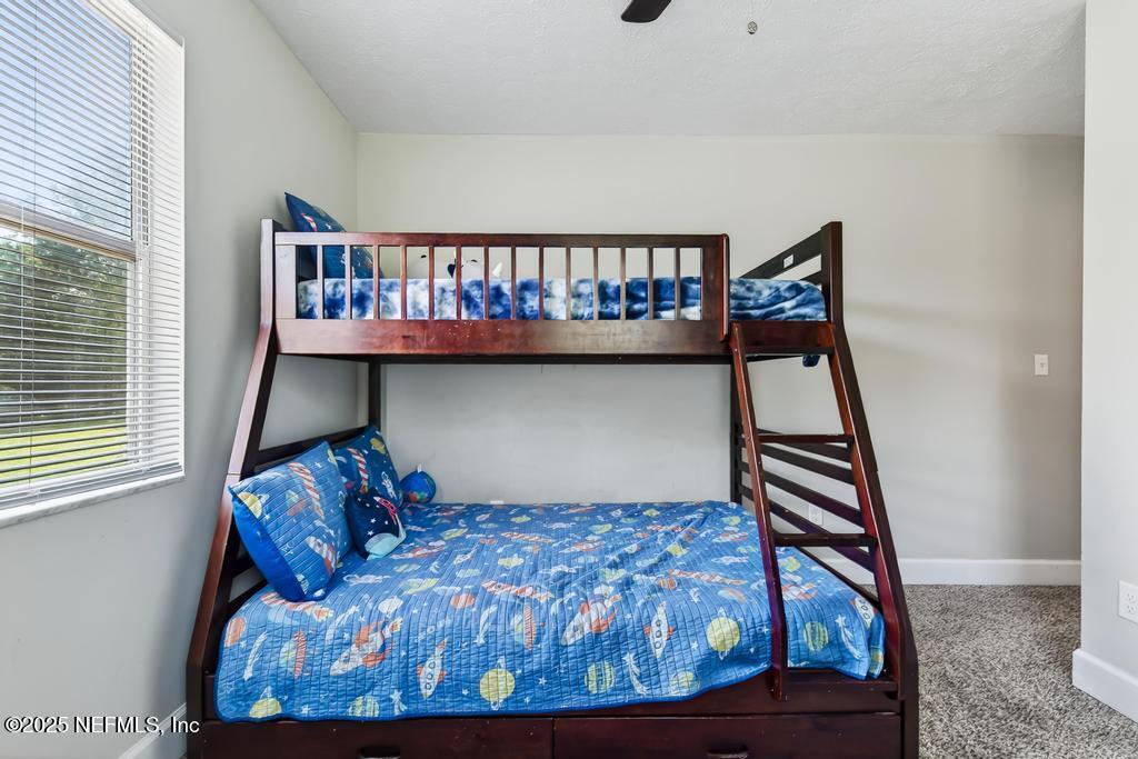 17080 Mcintosh Road Hilliard, FL 32046 - Photo 27 of 52 a bedroom with furniture and white walls