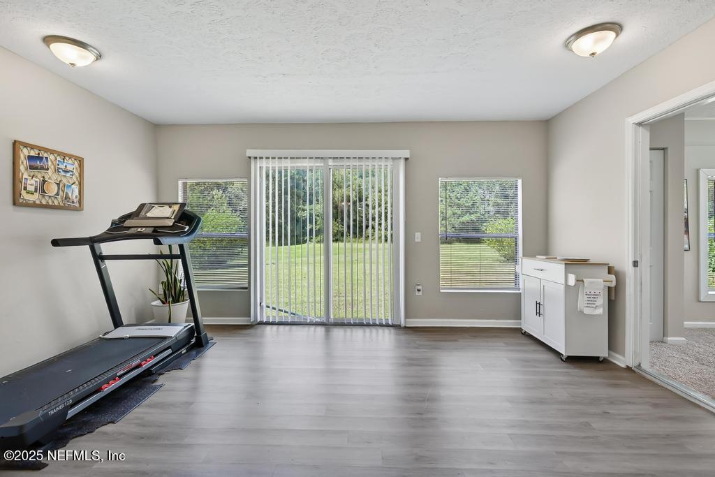 17080 Mcintosh Road Hilliard, FL 32046 - Photo 28 of 52 a view of room with furniture and wooden floor