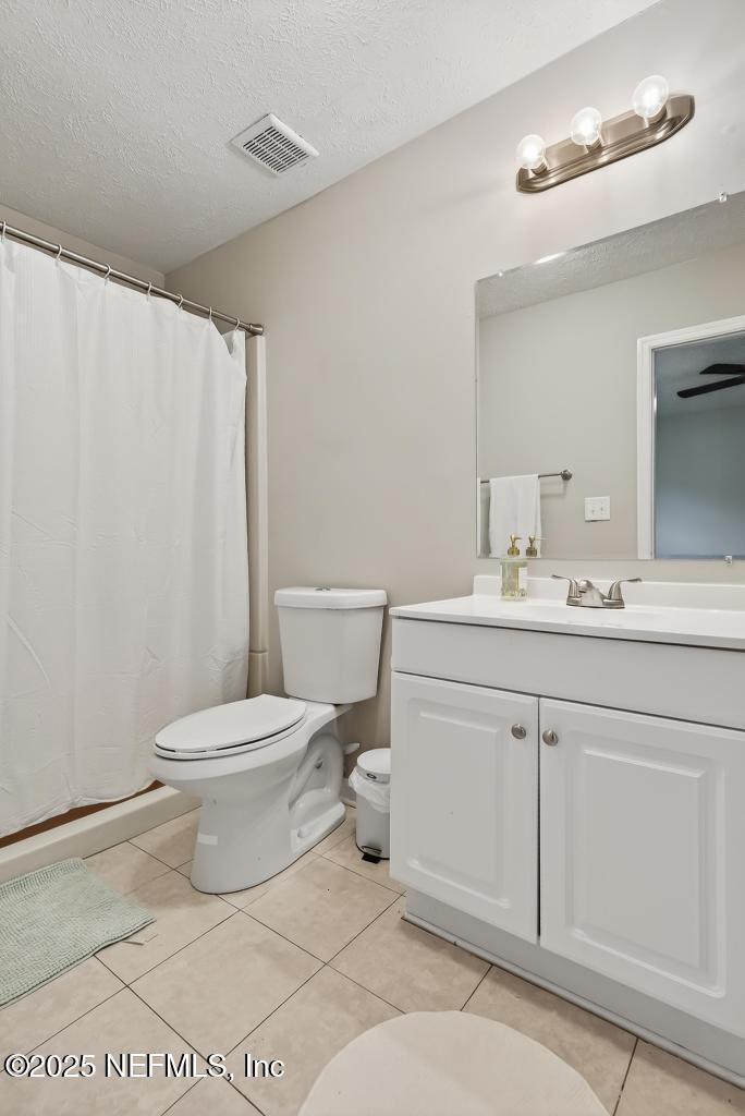 17080 Mcintosh Road Hilliard, FL 32046 - Photo 35 of 52 a bathroom with a toilet a sink and a mirror