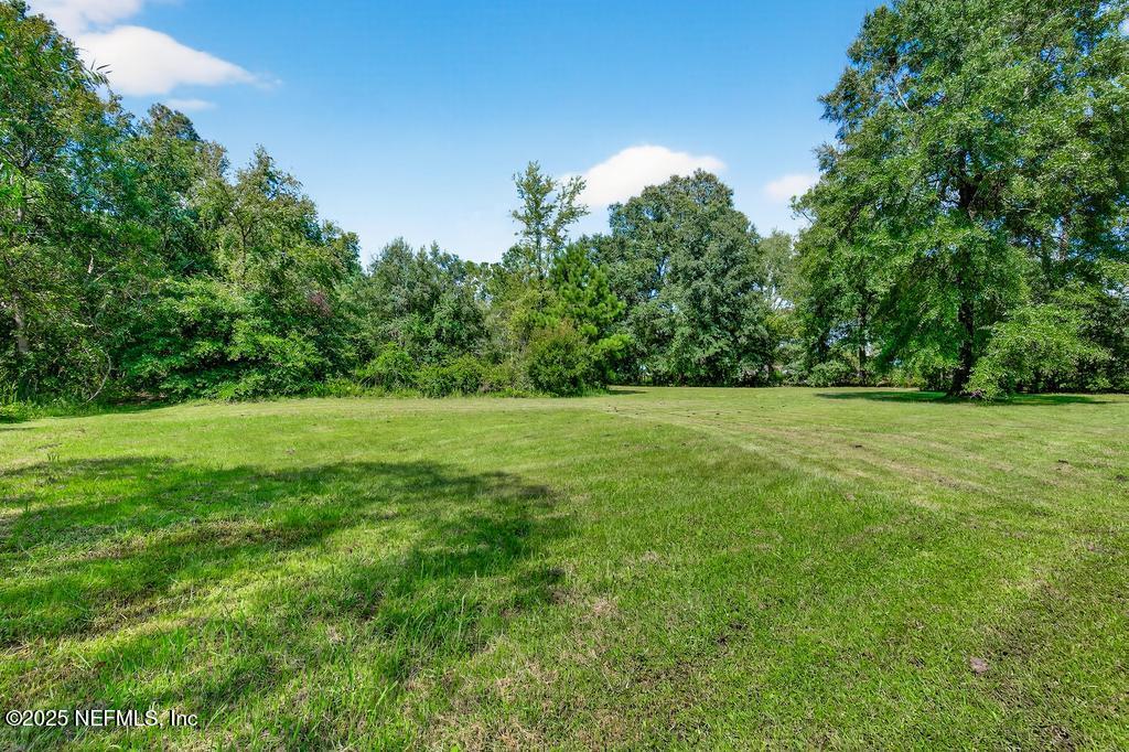 17080 Mcintosh Road Hilliard, FL 32046 - Photo 37 of 52 a view of a green field with wooden fence