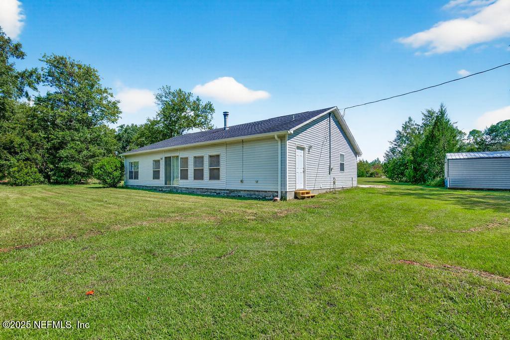17080 Mcintosh Road Hilliard, FL 32046 - Photo 39 of 52 a front view of house with yard and green space