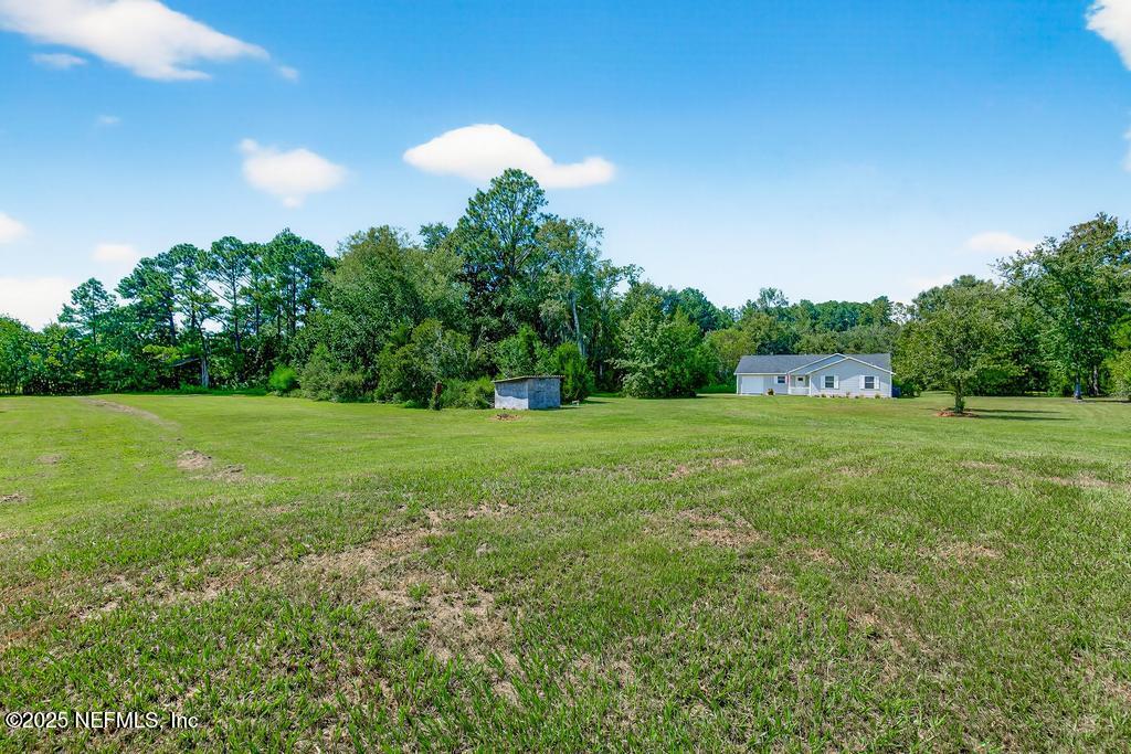 17080 Mcintosh Road Hilliard, FL 32046 - Photo 4 of 52 a view of a green field with wooden fence