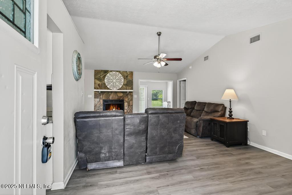 17080 Mcintosh Road Hilliard, FL 32046 - Photo 7 of 52 a living room with furniture and a fireplace