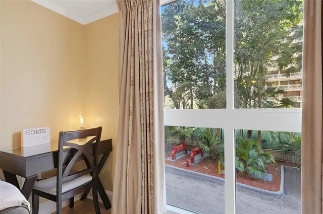 a large bed sitting in a bedroom next to a window