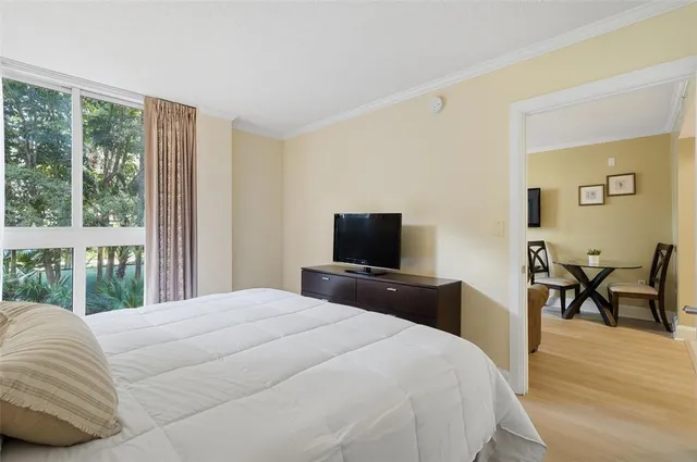 a dining room with furniture a rug and a large window