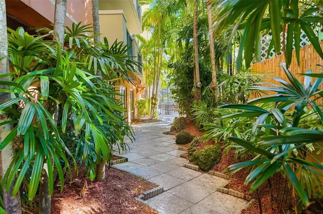 a view of swimming pool with outdoor seating and house in the background