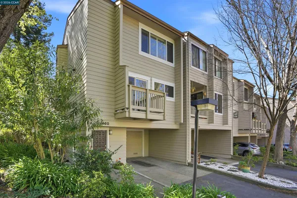 a view of a house with a yard and potted plants
