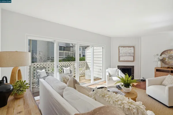 a dining room with furniture a chandelier and wooden floor