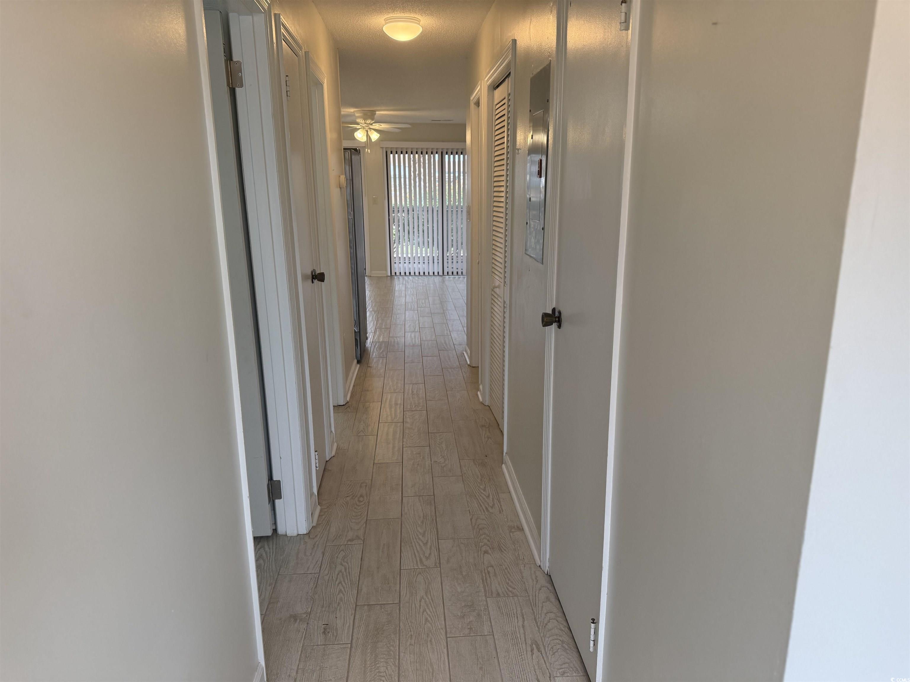 1850 Colony Drive, Unit 2S Myrtle Beach, SC 29575 - Photo 2 of 38 Hallway with light wood-style flooring and baseboards