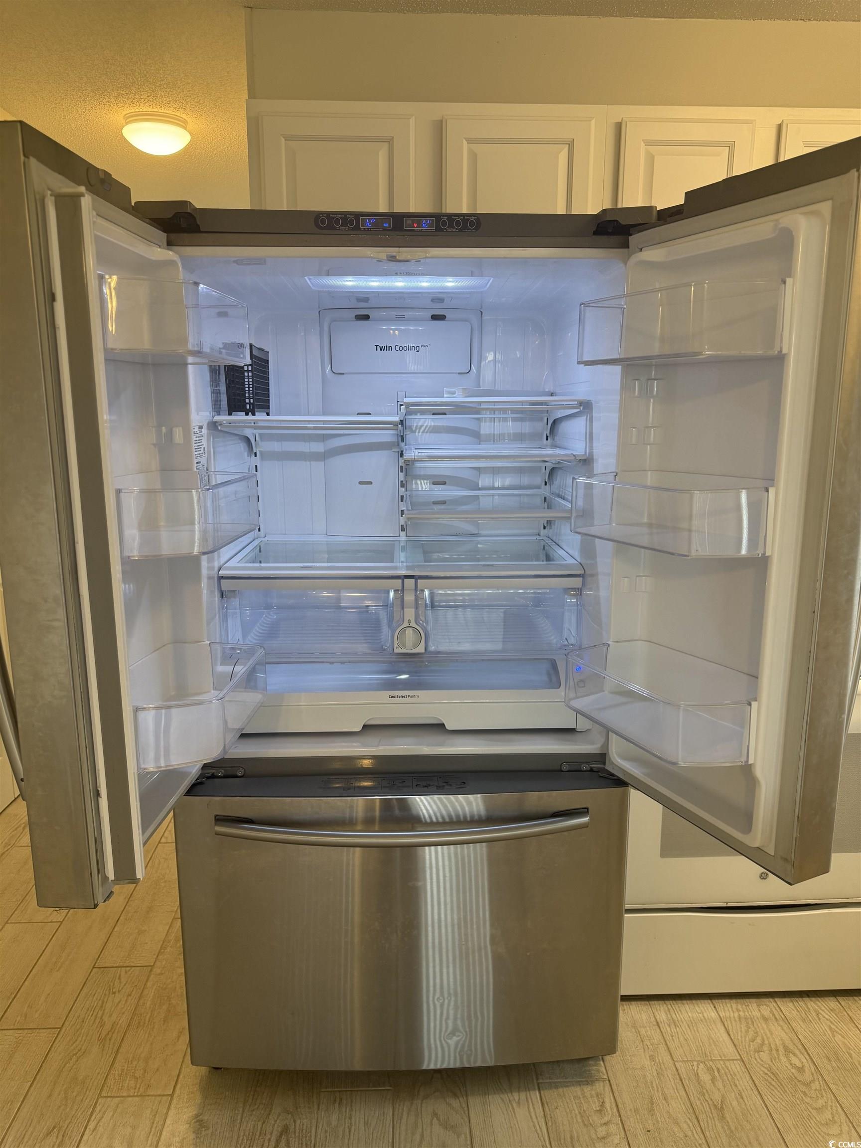 1850 Colony Drive, Unit 2S Myrtle Beach, SC 29575 - Photo 10 of 38 Kitchen view of light wood finished floors and freestanding refrigerator