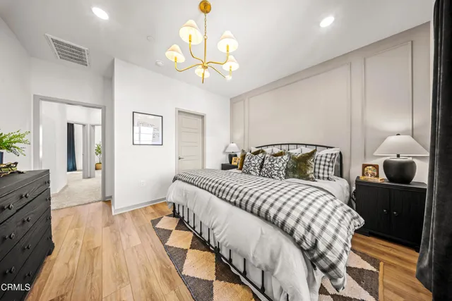 a bedroom with a bed and wooden floor