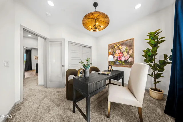 a view of a livingroom with furniture and a potted plant